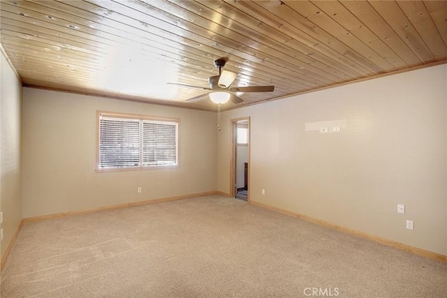 carpeted spare room with ceiling fan, ornamental molding, and wooden ceiling