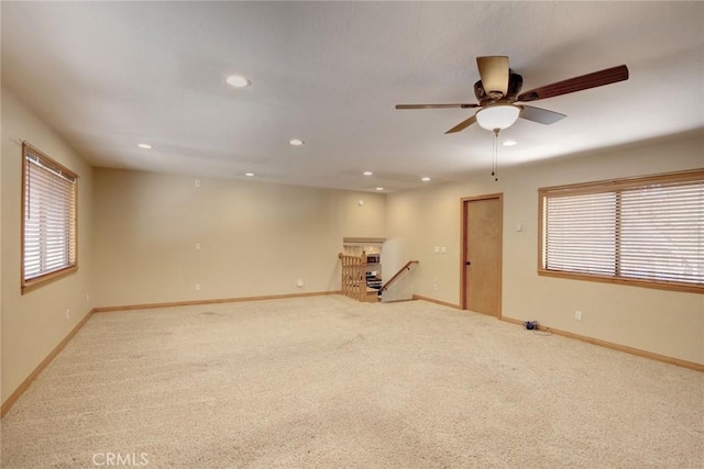 empty room with ceiling fan and light carpet