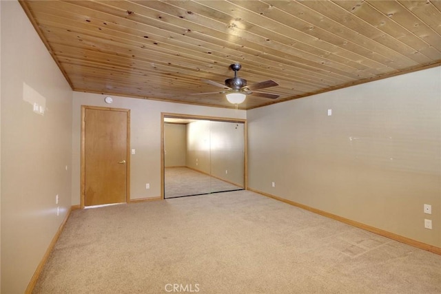 unfurnished bedroom with a closet, ceiling fan, wood ceiling, and light carpet