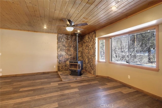 unfurnished living room featuring wood ceiling, dark wood-type flooring, ceiling fan, and a wood stove