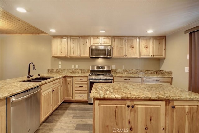 kitchen with sink, light brown cabinets, light hardwood / wood-style flooring, and appliances with stainless steel finishes