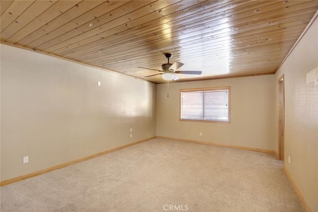 empty room featuring wooden ceiling, ceiling fan, crown molding, and light colored carpet