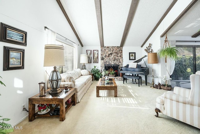 living room featuring carpet flooring, lofted ceiling with beams, a healthy amount of sunlight, and a stone fireplace