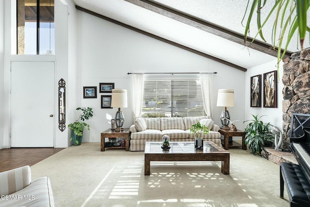 carpeted living room featuring high vaulted ceiling, beamed ceiling, and a stone fireplace