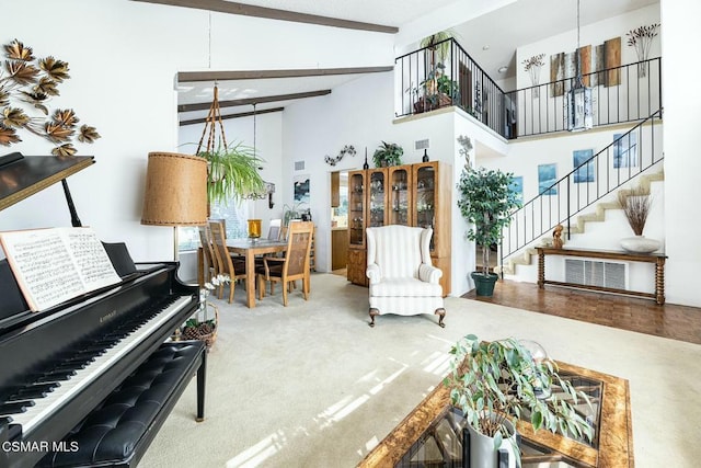 interior space with high vaulted ceiling, carpet, and beamed ceiling