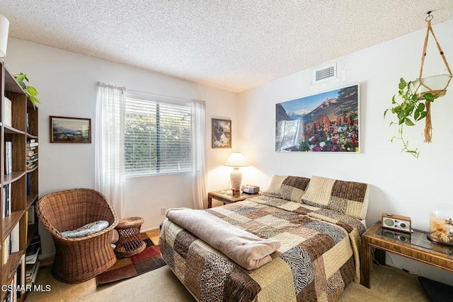 carpeted bedroom featuring a textured ceiling