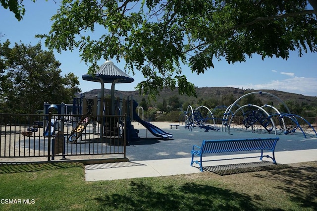 view of playground featuring a mountain view