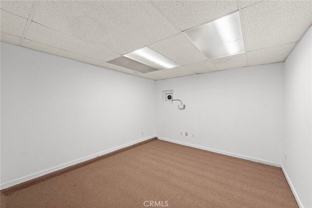 carpeted empty room with a paneled ceiling