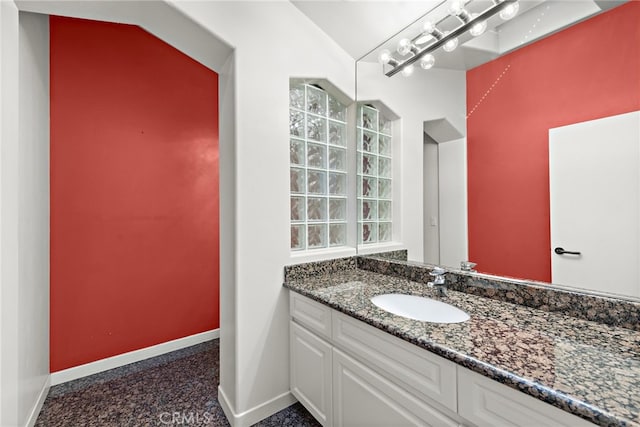 bathroom featuring vaulted ceiling and vanity