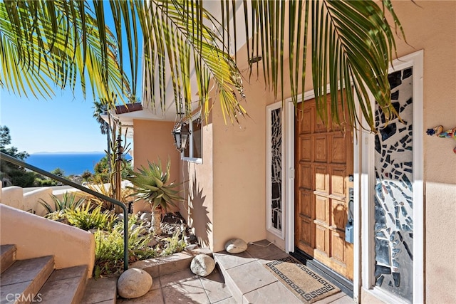 entrance to property with a water view