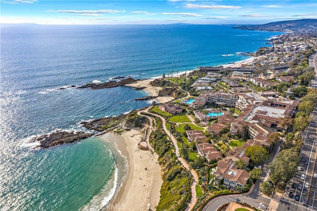 drone / aerial view featuring a beach view and a water view