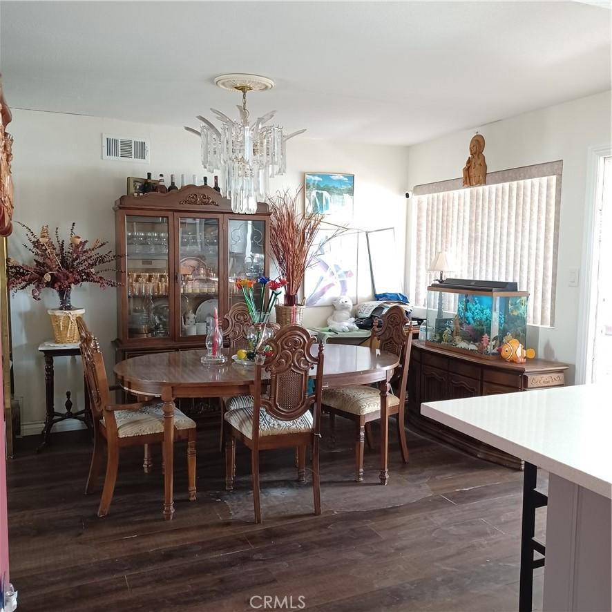 dining space with a chandelier and dark hardwood / wood-style floors