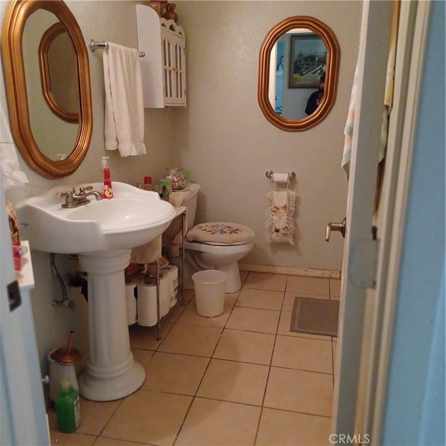 bathroom with tile patterned floors and toilet