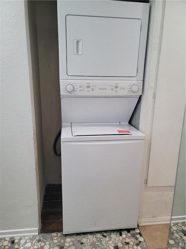 laundry area with stacked washer and dryer