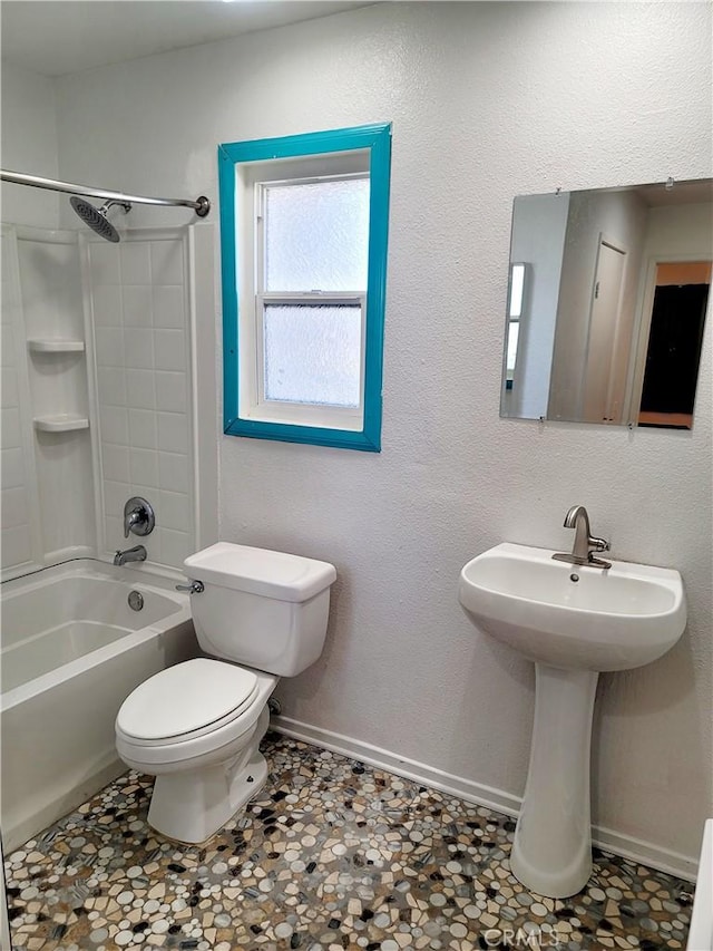 bathroom with toilet and washtub / shower combination