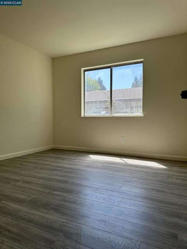 spare room with dark hardwood / wood-style floors