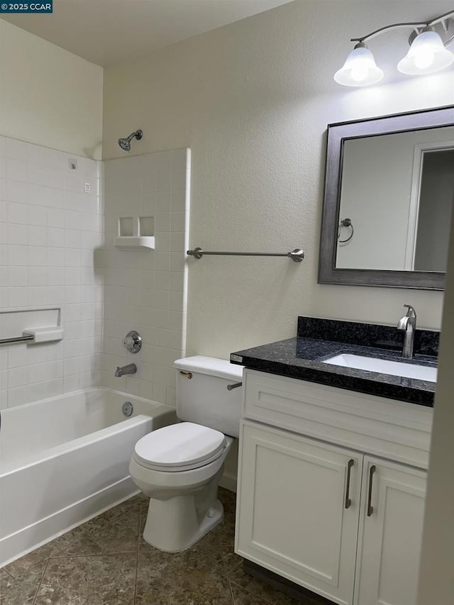 full bathroom with toilet, vanity, and tiled shower / bath