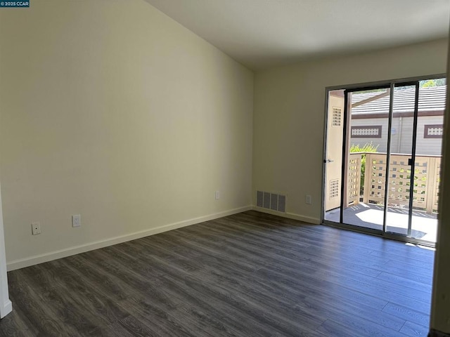 spare room with dark wood-type flooring