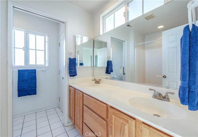 bathroom featuring vanity, tile patterned flooring, and walk in shower