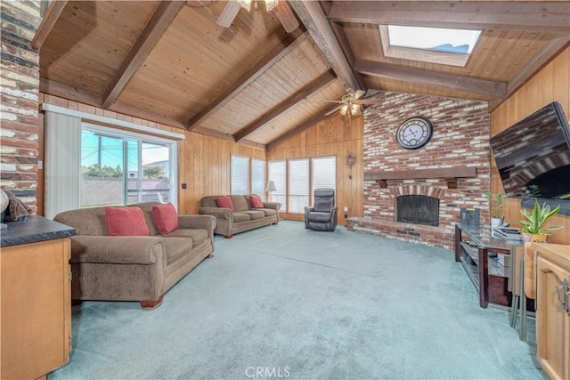 carpeted living room with wooden walls, a skylight, wooden ceiling, and beam ceiling