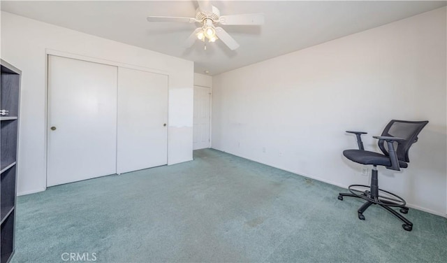 unfurnished office featuring carpet floors and ceiling fan