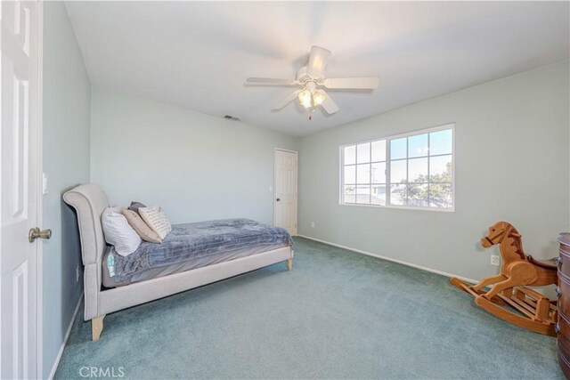 bedroom featuring ceiling fan and carpet