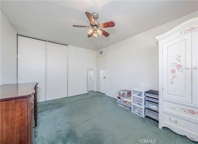 unfurnished bedroom with carpet flooring, a closet, and ceiling fan