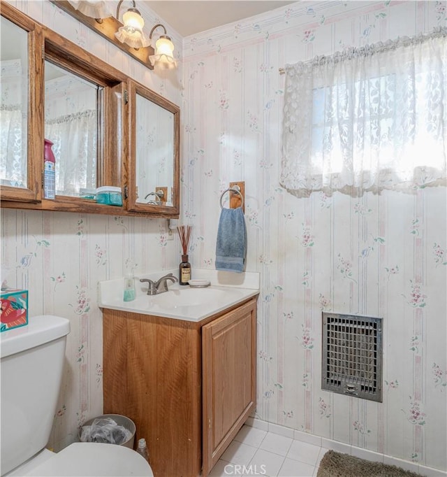 bathroom with toilet, heating unit, tile patterned floors, and vanity