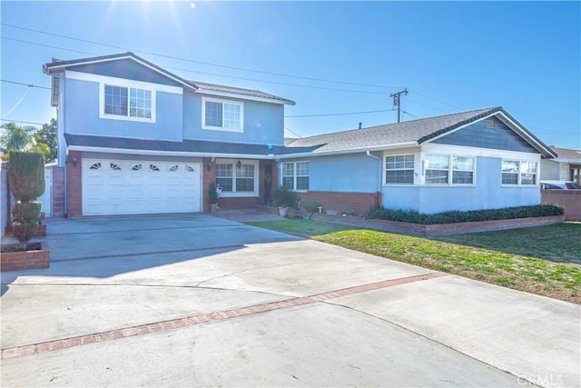 traditional-style house with a garage, stucco siding, driveway, and a front lawn