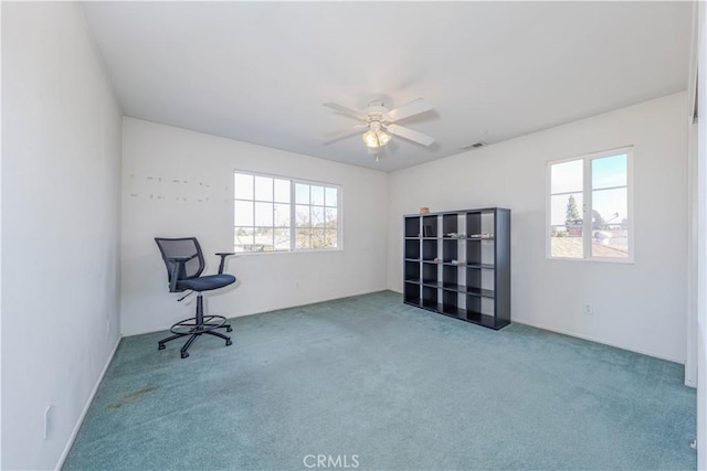 interior space featuring ceiling fan and carpet