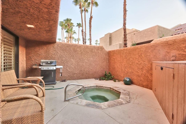 view of patio featuring grilling area and an in ground hot tub