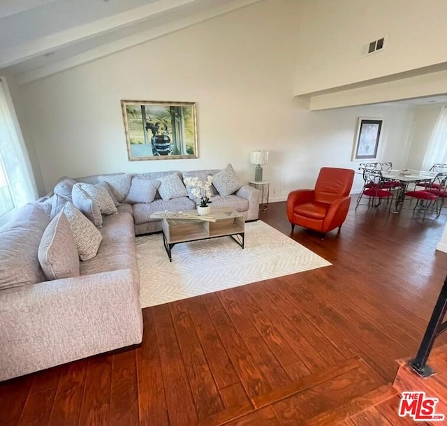 living room featuring hardwood / wood-style floors, beam ceiling, and high vaulted ceiling