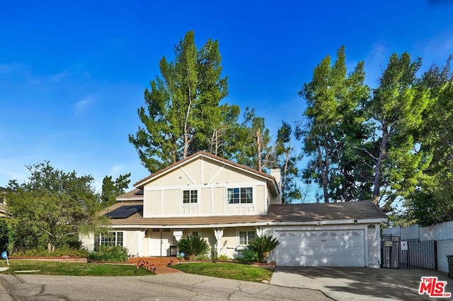 view of front of property with a garage and solar panels