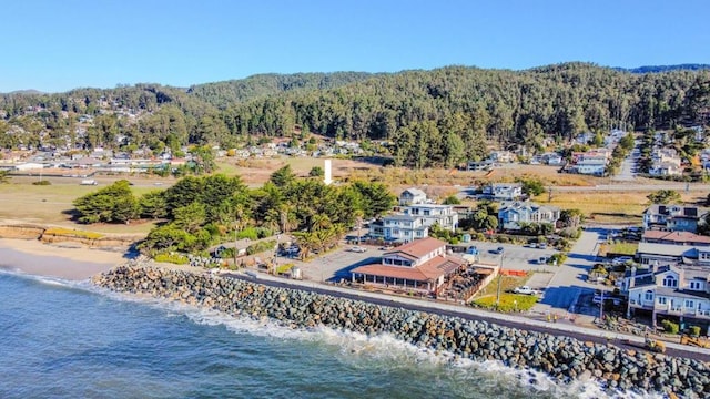 birds eye view of property with a beach view and a water view