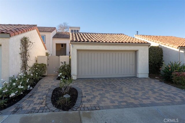 mediterranean / spanish home featuring a garage