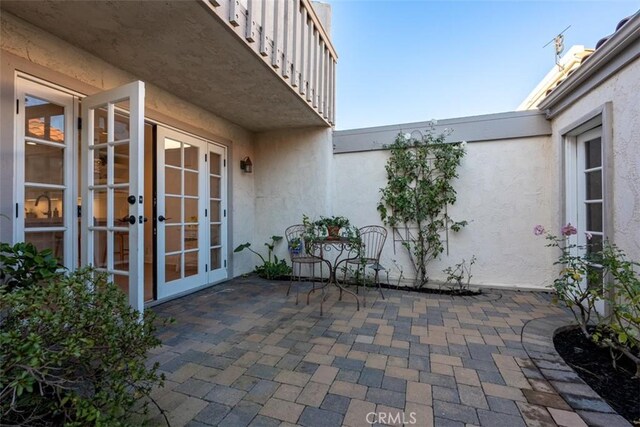 view of patio / terrace featuring french doors and a balcony