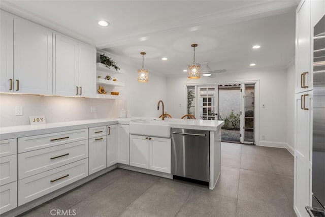 kitchen with light countertops, a sink, a peninsula, and stainless steel dishwasher