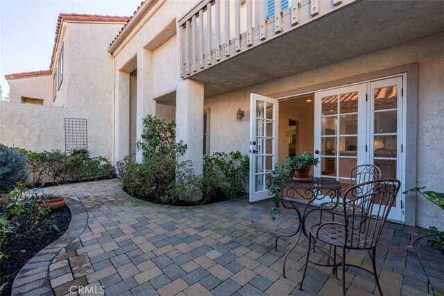 view of patio / terrace with a balcony and french doors