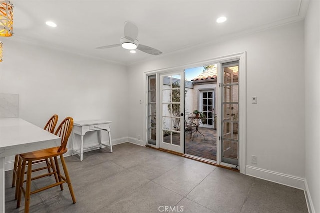 dining space with ceiling fan, concrete floors, and ornamental molding