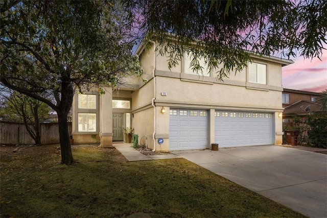 view of front of property featuring a yard and a garage