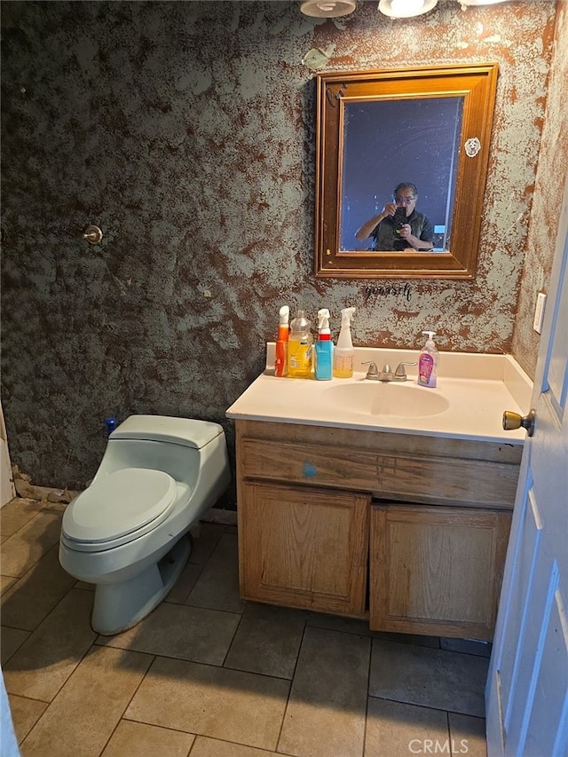 bathroom featuring toilet, tile patterned flooring, and vanity