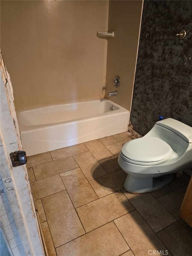 bathroom with toilet, shower / bathtub combination, and tile patterned floors