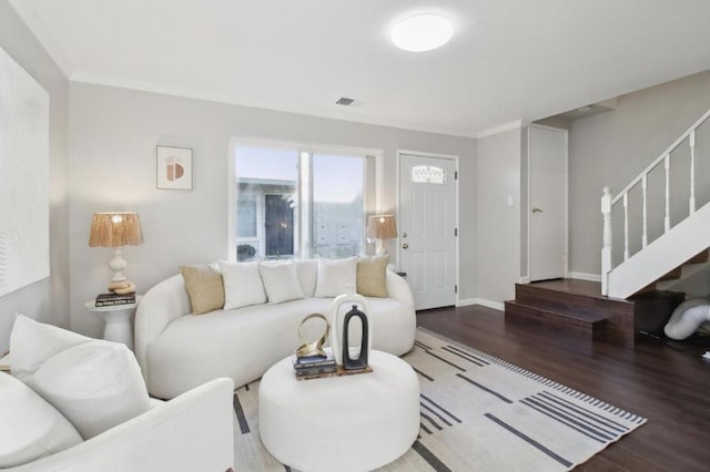 living room with hardwood / wood-style flooring and ornamental molding