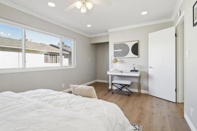 bedroom featuring ceiling fan, light hardwood / wood-style flooring, and ornamental molding