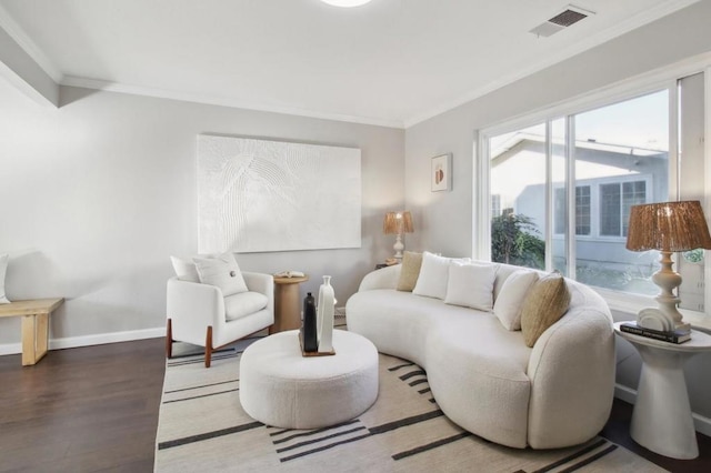 living room featuring hardwood / wood-style flooring, crown molding, and a wealth of natural light