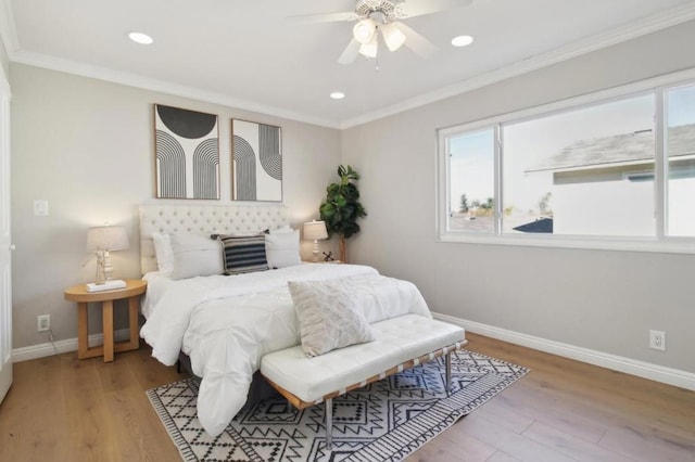 bedroom featuring ceiling fan, ornamental molding, and light hardwood / wood-style flooring