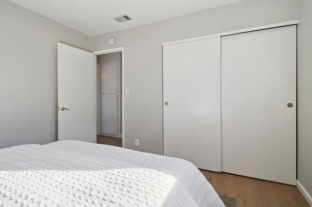 bedroom featuring a closet and hardwood / wood-style flooring