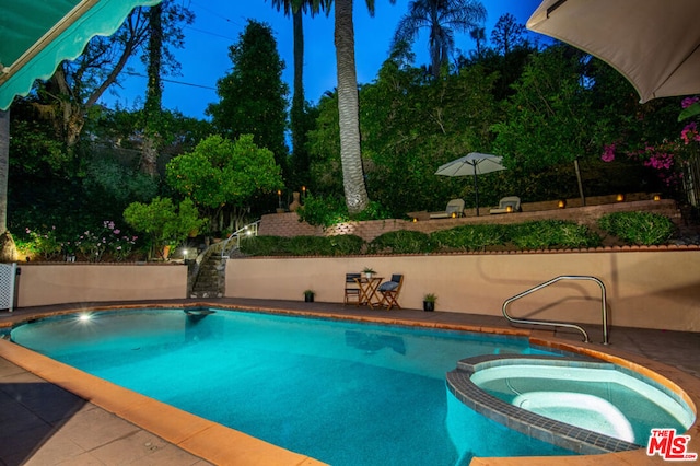 view of swimming pool featuring an in ground hot tub