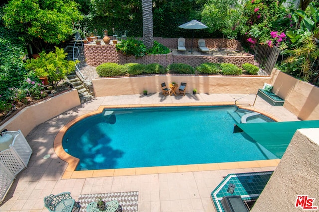 view of pool featuring a patio