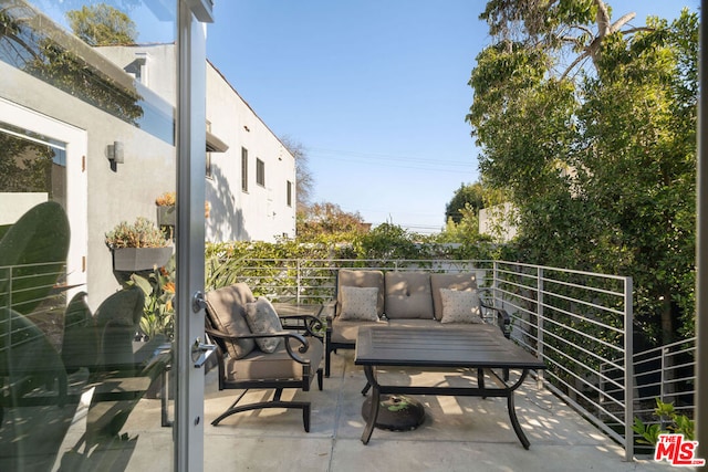 view of patio / terrace featuring a balcony and an outdoor living space